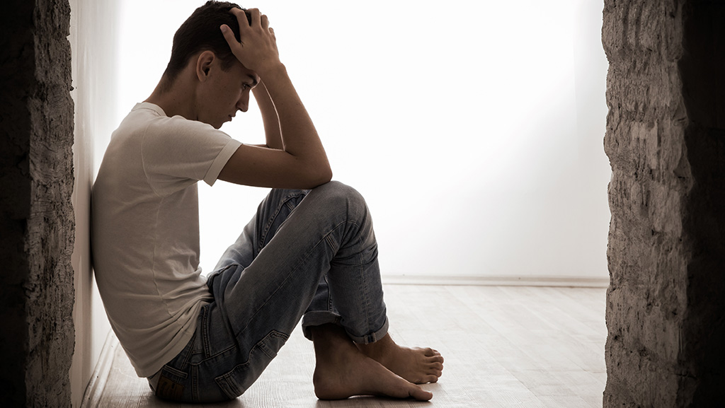 Depressed man sitting on the floor